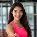 Happy client Anna Wong giving a thumbs up at the gym.